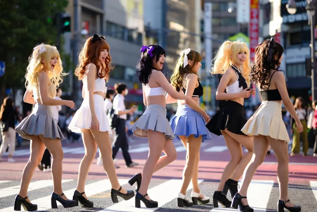 Group of gyaru girls in full outfits crossing Shibuya scramble, 2026 street fashion moment